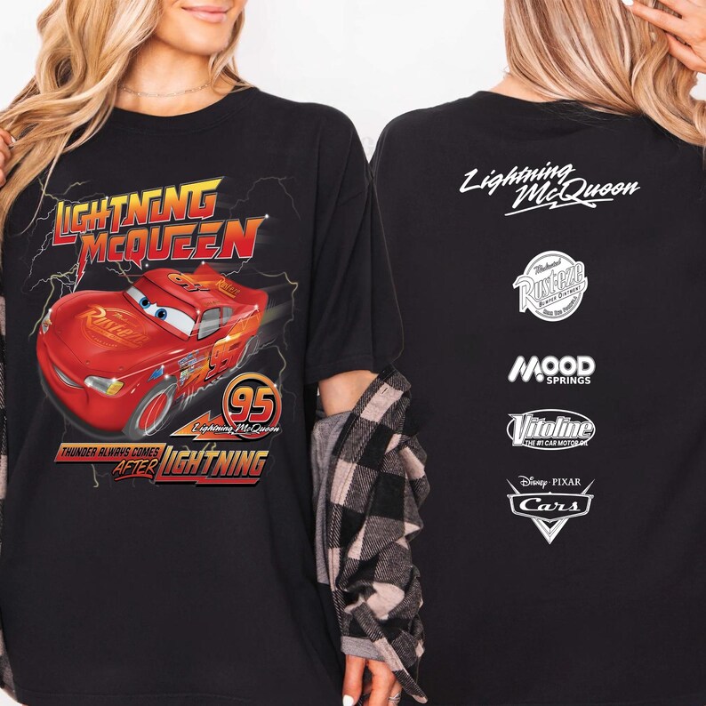 May include: Black t-shirt featuring Lightning McQueen from the Disney Pixar Cars movie. The front graphic shows McQueen with the text "Lightning McQueen" and "Thunder Always Comes After Lightning". The back has the text "Lightning McQueen" and other logos.
