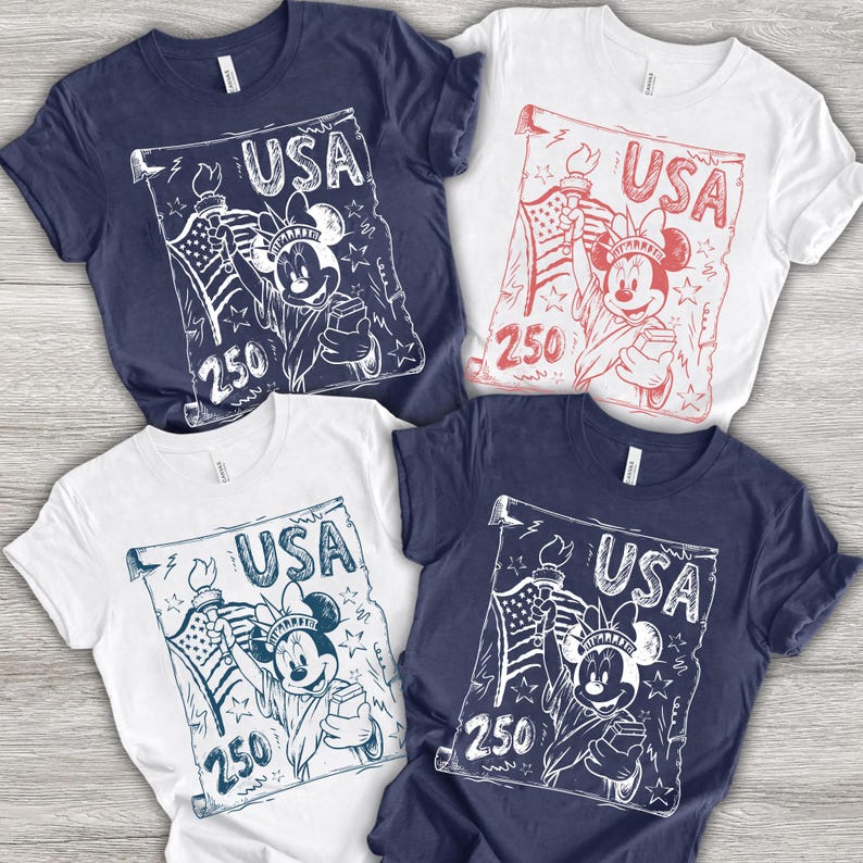 May include: Four t-shirts in navy blue and white. Each shirt features a graphic of a cartoon character holding a torch and a scroll with the word "USA" and the number "250".