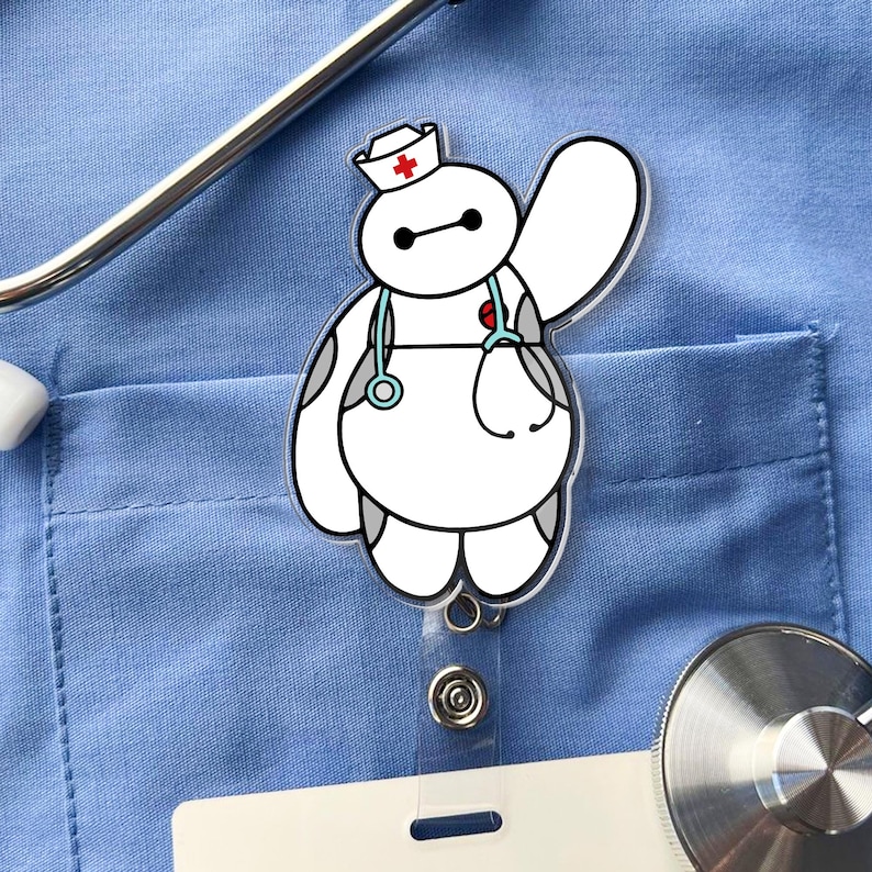 May include: A white, rounded character badge reel featuring a nurse hat with a red cross, a light blue stethoscope draped around its neck, and one arm raised in a wave. The character has black eyes and gray accents on its body.