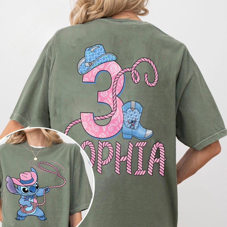 May include: Olive green t-shirt featuring a pink number 3 with a paisley design, a cowboy hat, and a blue boot with a cartoon character. The name "Sophia" is printed below the number in pink. A smaller image of the character is in the corner.
