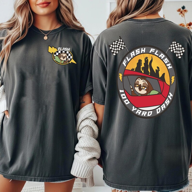 May include: Dark gray t-shirt with a cartoon sloth driving a red car, the text "FLASH FLASH 100 YARD DASH" is printed on the back. The front of the shirt has a smaller version of the sloth and car design with the word "FLASH".