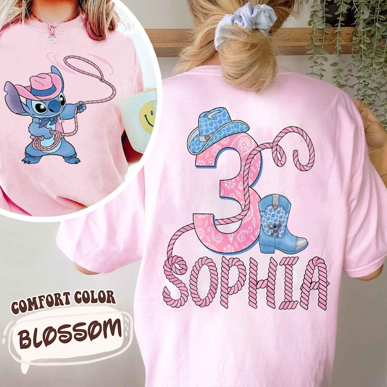 May include: Pink Comfort Color t-shirt with a cartoon Stitch character wearing a cowboy hat and holding a lasso. The back features a pink number 3, a cowboy hat, a boot, and the name "Sophia" in a rope-like font.