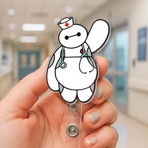 May include: An acrylic badge reel featuring a white, rounded robot character wearing a nurse cap with a red cross and a light blue stethoscope around its neck. The character has black eyes and is waving one arm, attached to a clear plastic clip.