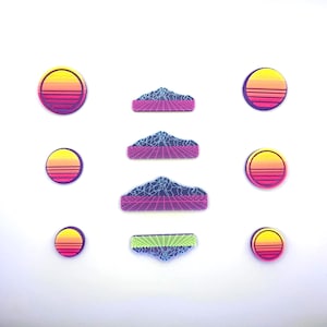 May include: A set of eight retro-style iron-on patches featuring a mountain range with a grid pattern and a sunset design. The patches are in shades of pink, blue, yellow, and green.