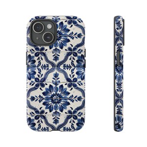 May include: A white and blue phone case with a floral pattern inspired by Portuguese tiles. The case is designed for an iPhone.