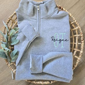 An oxford sweatshirt with mint julep for OT and black thread for the name.