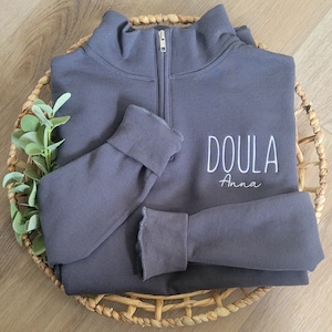 A charcoal grey sweatshirt with white thread.