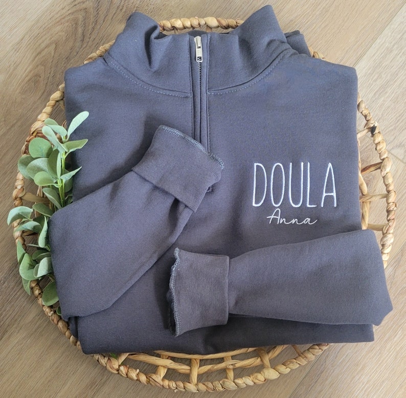 A charcoal grey sweatshirt with white thread.