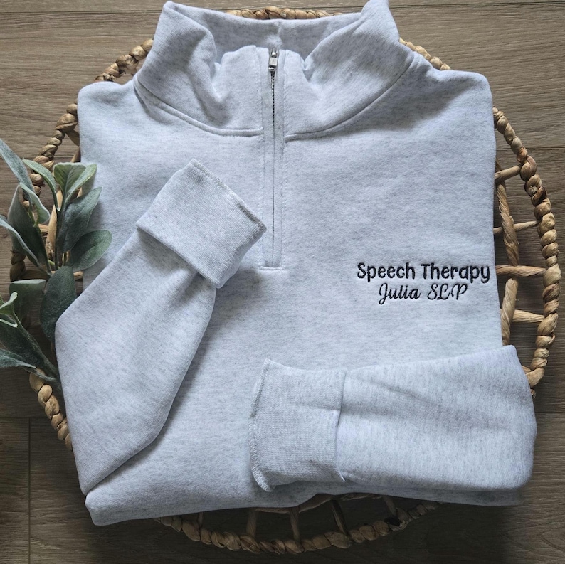 An ash quarter zip with black thread.