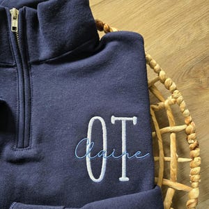 A navy sweatshirt with white thread for OT and sky blue for the name.