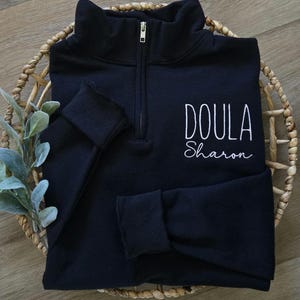 A black sweatshirt with blush thread.