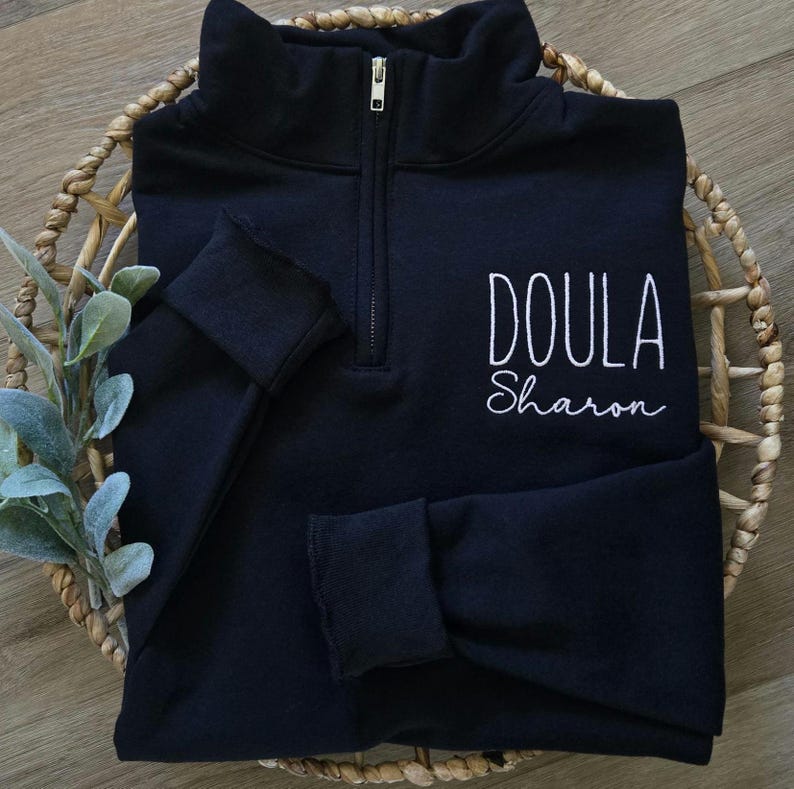A black sweatshirt with blush thread.
