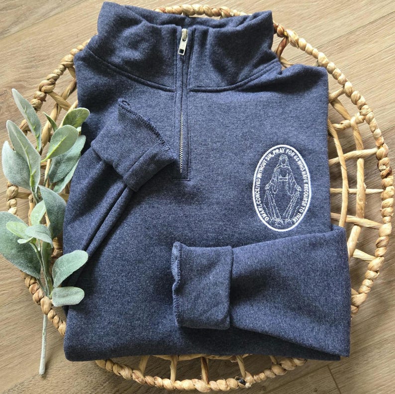 A vintage heather navy sweatshirt with white thread.