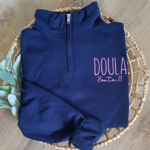 A navy sweatshirt with neon pink thread.