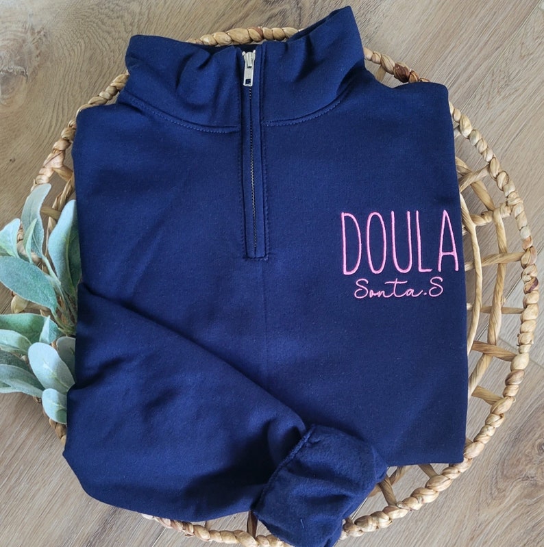 A navy sweatshirt with neon pink thread.