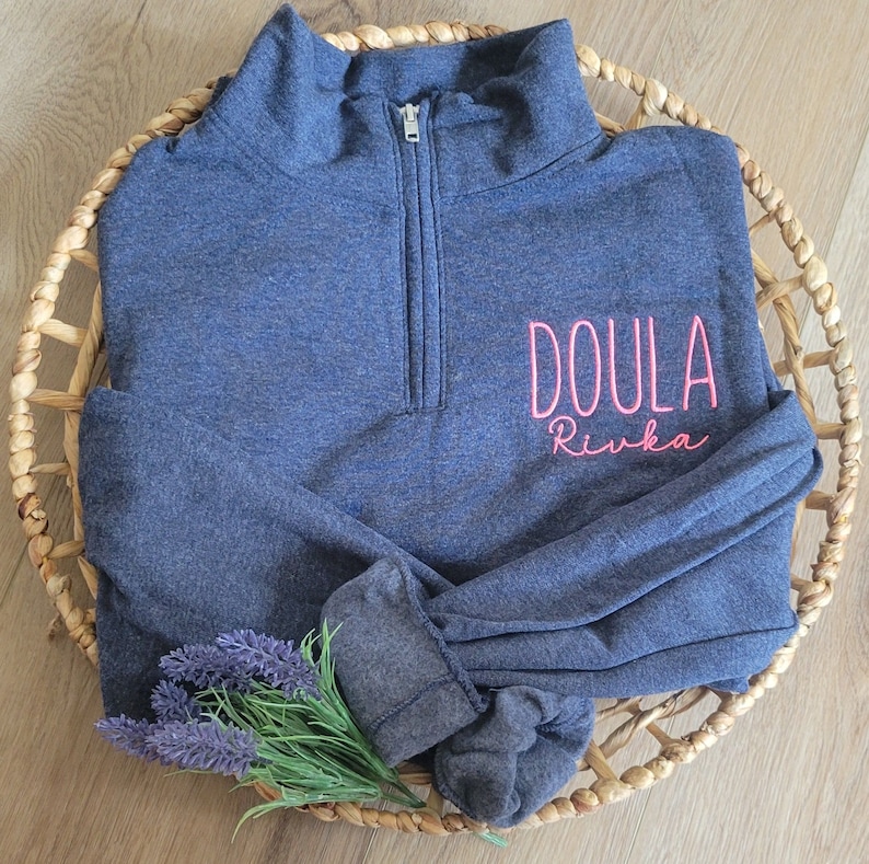 A vintage heather navy sweatshirt with neon pink thread.