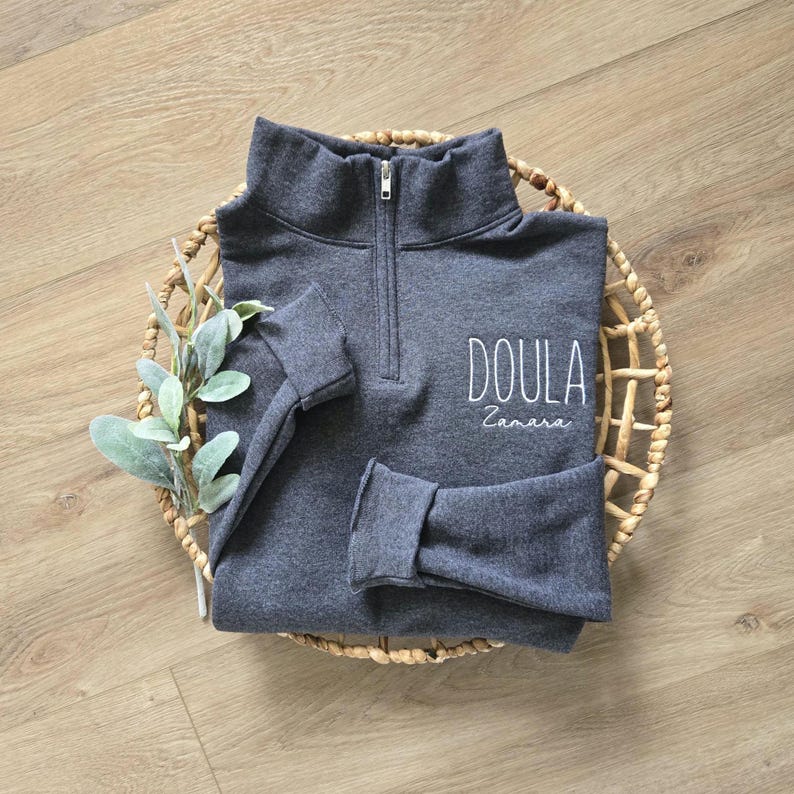 A black heather quarter zip with white thread.