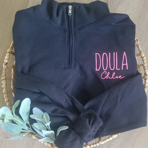 A black sweatshirt with neon pink thread.