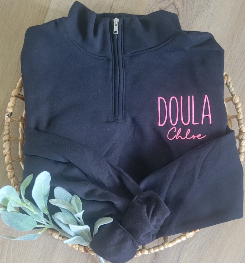 A black sweatshirt with neon pink thread.
