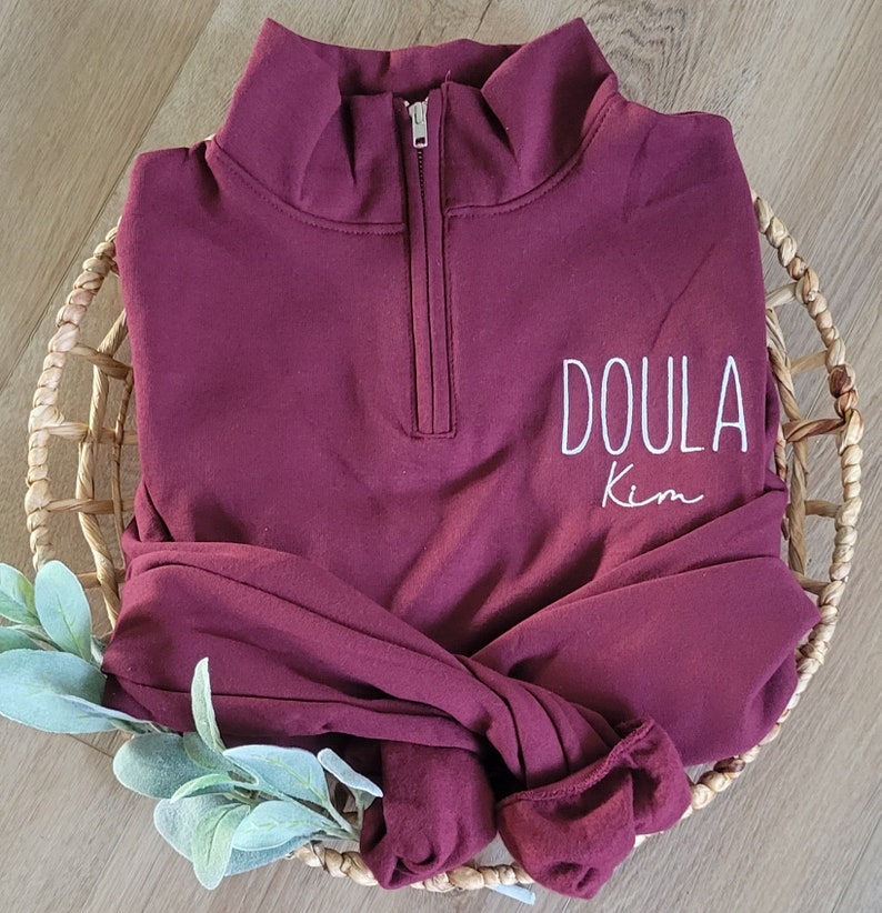 A maroon sweatshirt with white thread.