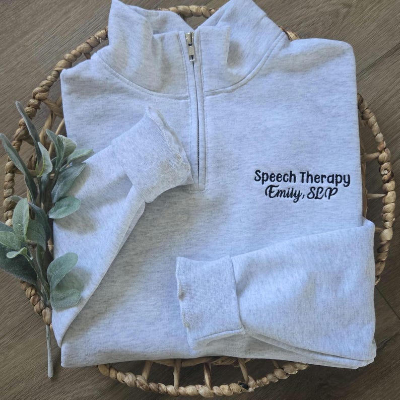 An ash quarter zip with black thread.