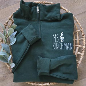 A forest green sweatshirt with white thread.