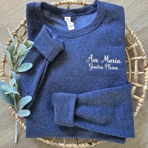 A vintage heather navy sweatshirt with blush thread.