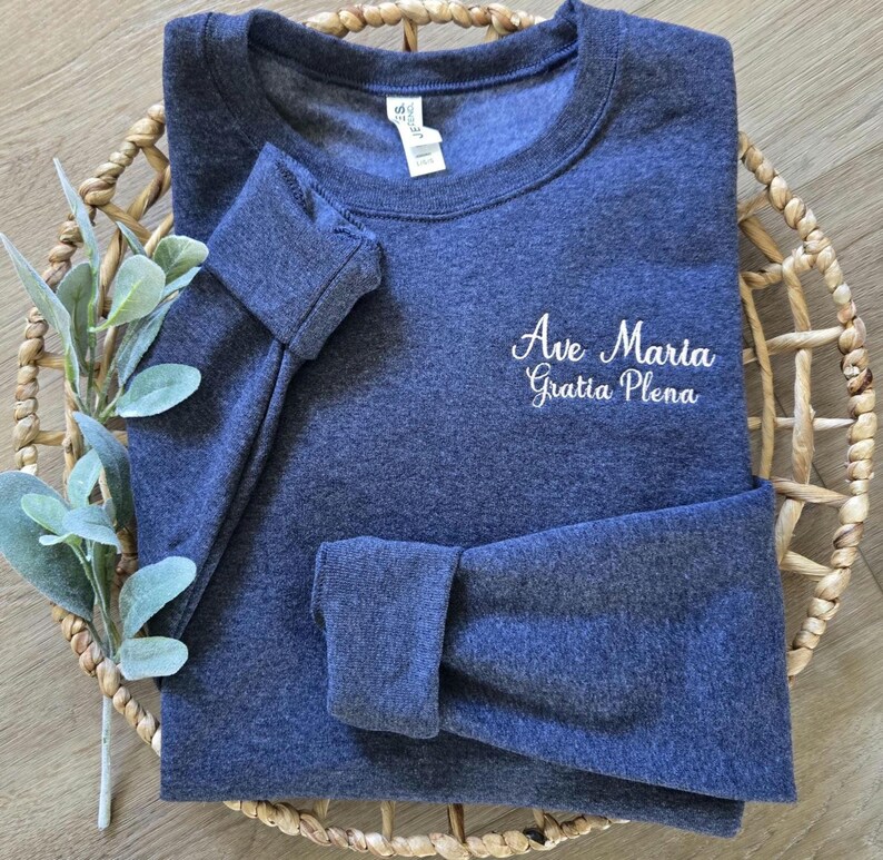 A vintage heather navy sweatshirt with blush thread.