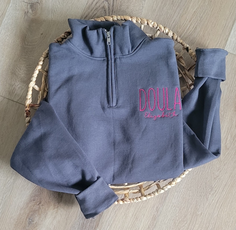 A charcoal sweatshirt with fuschia thread.