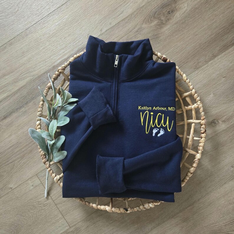 A navy sweatshirt with yellow and white thread.