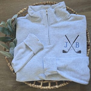 An ash sweatshirt with sky blue thread for the initials.