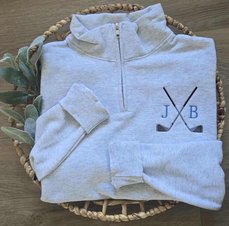 An ash sweatshirt with sky blue thread for the initials.