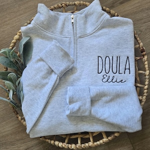 An ash sweatshirt with black thread.