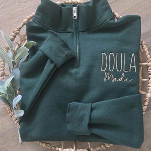 A forest green sweatshirt with vegas gold thread.