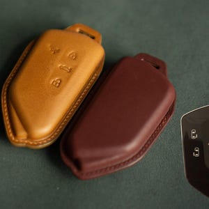 May include: A set of three ceramic mugs with a speckled, matte finish. The mugs are in shades of cream, light gray, and dark gray. Each mug has a simple, minimalist design and a rounded handle. The mugs are suitable for coffee, tea, or other beverages.