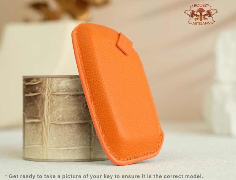 May include: Orange leather key cover with a textured surface.  *Get ready to take a picture of your key to ensure it is the correct model.