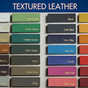 May include: A chart displaying 18 textured leather swatches in a range of colours, including white, mint green, black, light yellow, forest green, dark blue, yellow, taupe, viridian green, navy blue, light orange, gold, dark green, blue sky, orange red, medium brown, olive, cobalt, red, violet, stone grey, light pink, dark red, cloud grey, grey, taffy pink, and bordeaux.