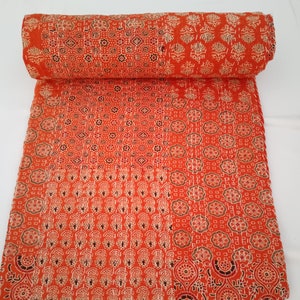 May include: A hand-stitched kantha quilt in a vibrant orange colour with a patchwork design featuring various floral and geometric patterns.