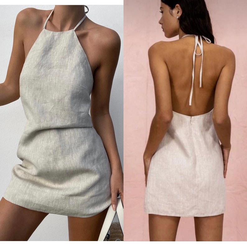 May include: A light beige linen halter dress with a tie back. The dress is sleeveless and has a mini length.