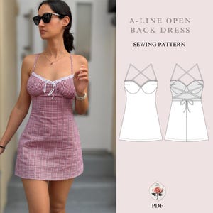 May include: A-line open back dress sewing pattern. The pattern includes a front and back view of the dress. The dress has a fitted bodice and a flowing skirt. The back of the dress has a criss-cross strap design and a tie at the waist. The pattern is available in PDF format.