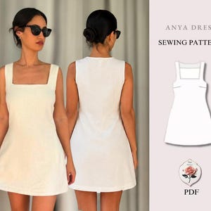 Könnte beinhalten: Ein ärmelloses, cremeweißes Minikleid mit quadratischem Ausschnitt und schlichter, gerader Silhouette. Das Bild enthält eine technische Strichzeichnung des Anya Dress Schnittmusters und eine kleine Rosengrafik mit dem Text PDF darunter.