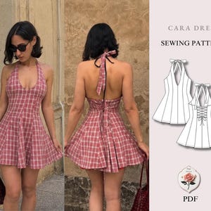 May include: A Cara Dress sewing pattern PDF featuring a red and white plaid halter dress with a deep neckline, an open back with tie straps, and a flared skirt. The image includes a technical line drawing of the front and back of the garment.