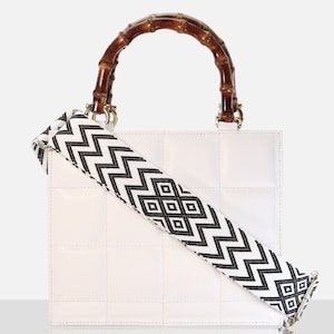 Top handle stylish Italian Handbag with matching pattern strap and bamboo handle. Genuine italian leather. White