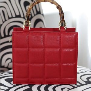 Top handle stylish Italian Handbag with matching pattern strap and bamboo handle. Genuine italian leather. Red
