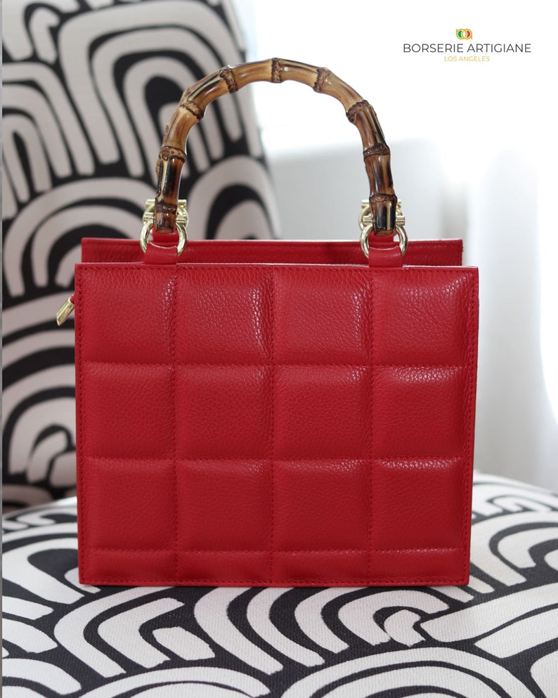 Top handle stylish Italian Handbag with matching pattern strap and bamboo handle. Genuine italian leather. Red