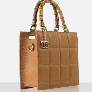 Top handle stylish Italian Handbag with matching pattern strap and bamboo handle. Genuine italian leather. Natural Leather