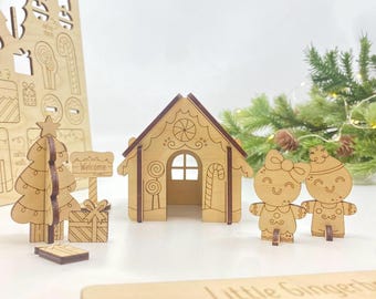 May include: Wooden Christmas-themed decorations, including a gingerbread house, gingerbread people, a Christmas tree, and a welcome sign. The decorations are made of light brown wood with darker brown accents. A festive holiday scene.