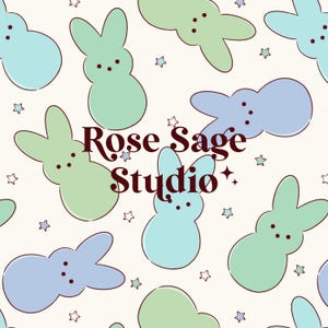 May include: A repeating pattern of pastel blue and green bunny shapes with black dot eyes and small star shapes on a cream background. The text "Rose Sage Studio" is in the center of the image.
