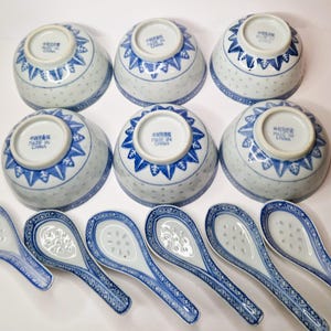 May include: Set of six blue and white porcelain bowls with a floral design and six matching spoons. The bowls and spoons are made in China.