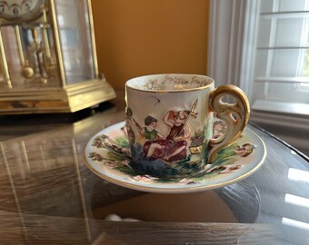 Vintage Demitasse cup and saucer, SGK, raised cherubs, gilded